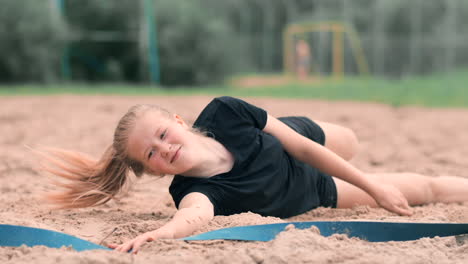 Slow-motion:-a-Young-woman-jumping-in-the-fall-hits-the-ball-on-the-sand.-Volleyball-player-makes-a-team-and-plays-the-ball-off-in-the-fall.